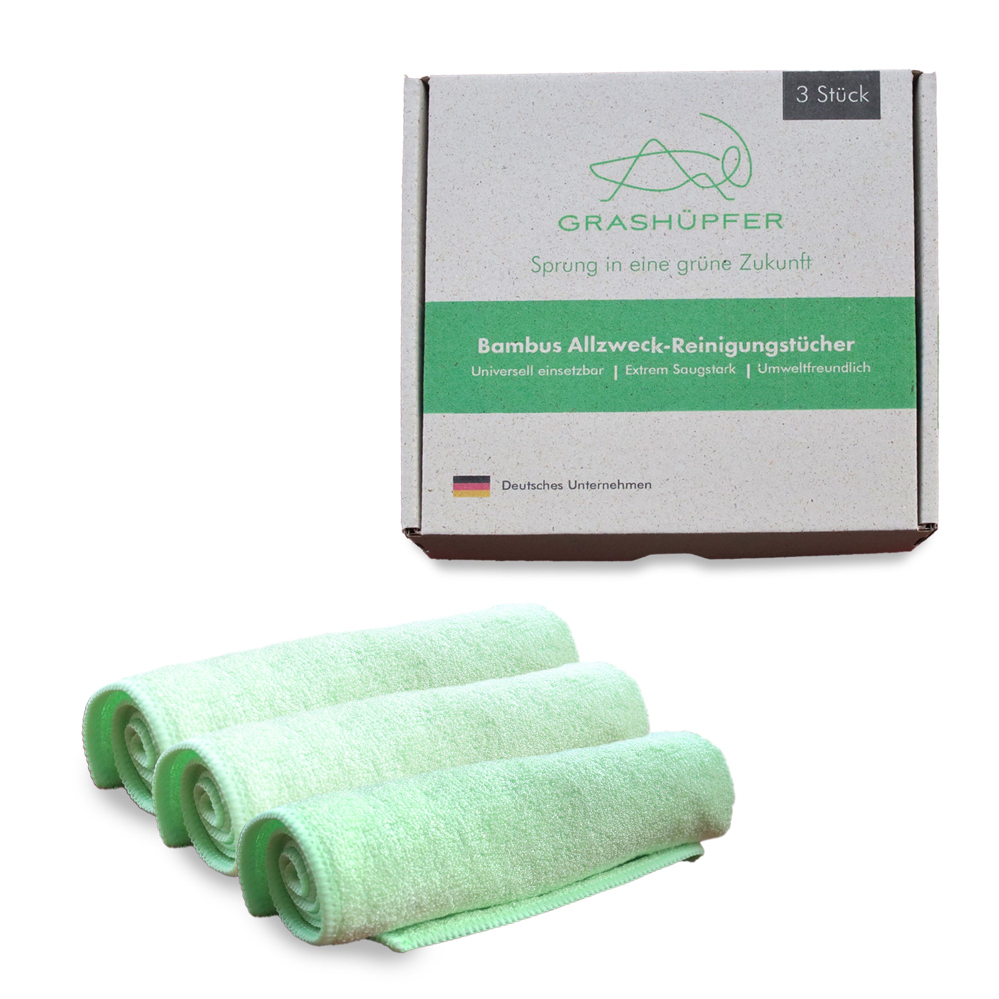 Die Bambus Allzwecktücher von Grashüpfer, 3 Stück, aufgerollt und die Produktverpackung ist daneben zu sehen.