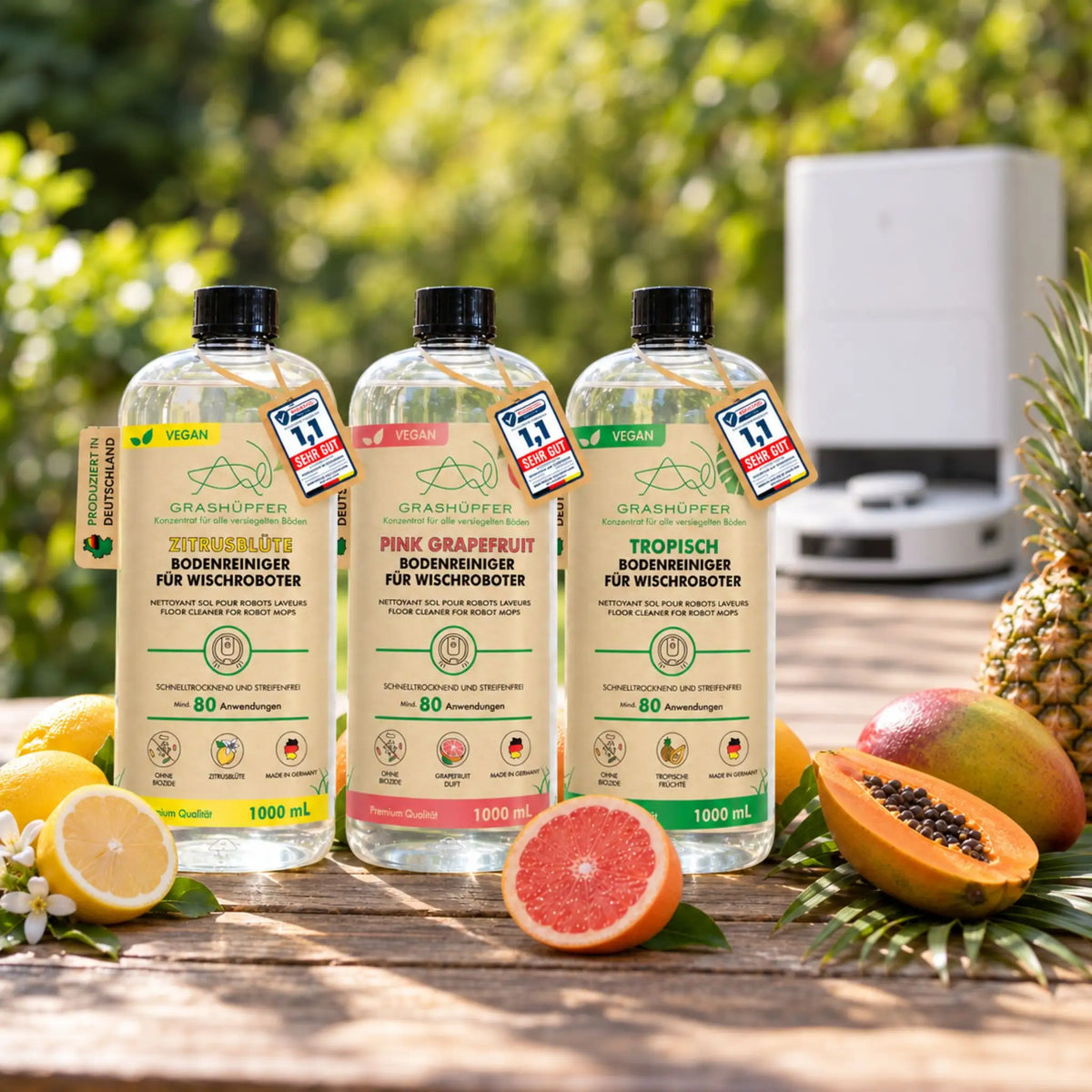 Drei GRASHÜPFER Bodenreiniger für Wischroboter in Zitrusblüte, Pink Grapefruit und Tropisch mit Saugroboter.